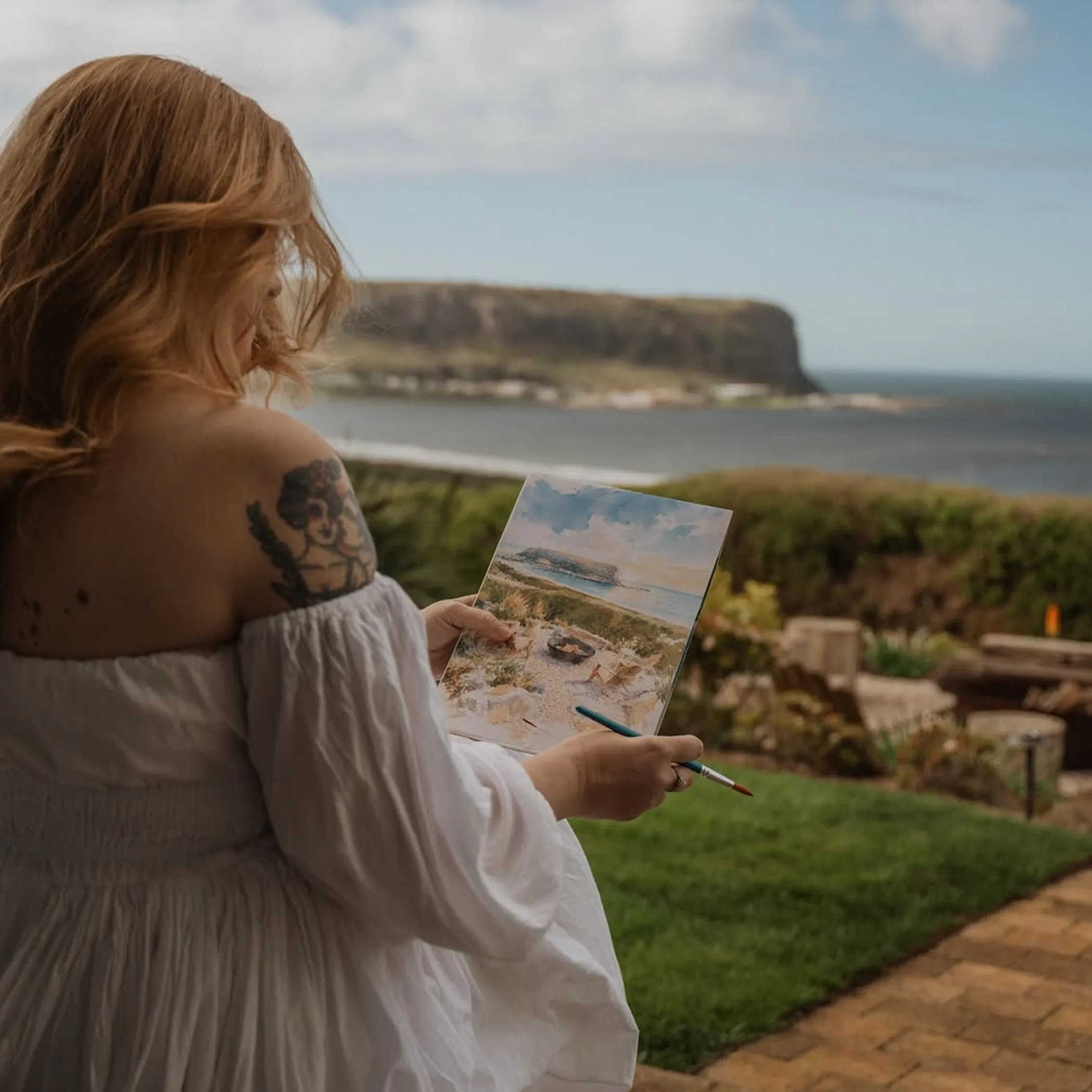 visitor enjoying art by tasmanian coast